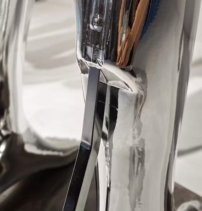 Chrome leg support and floor mounting detail